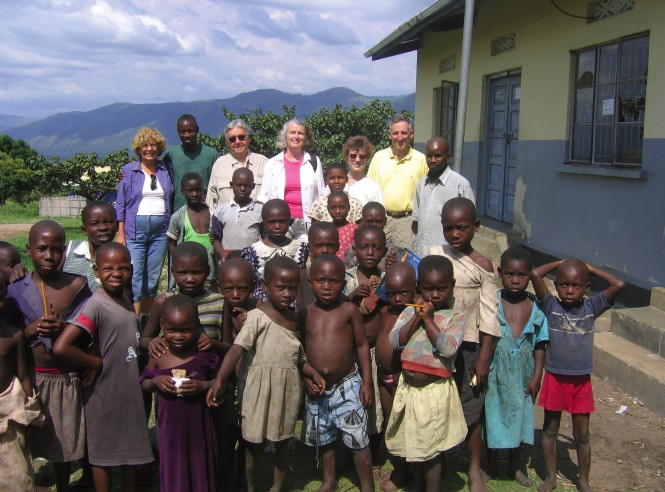 Deborah Walker, shown here (back row, center) visiting a clinic in Uganda, says she’s in public health because it is “the practice of social justice.”