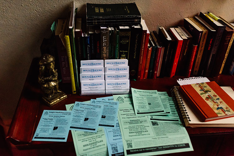 Spiritual books are positioned on a table with flyers.