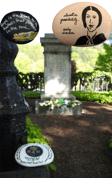 Several rocks: one rock is painted eggshell white with a sketch of Emily Dickinson and reads, "dwell in possibility..."; another is painted black with a feather and reads, "Hope is the thing with feathers that perches in the soul”; the third, placed near Mary Lyon’s grave, has the lyrics of “Bread and Roses.”